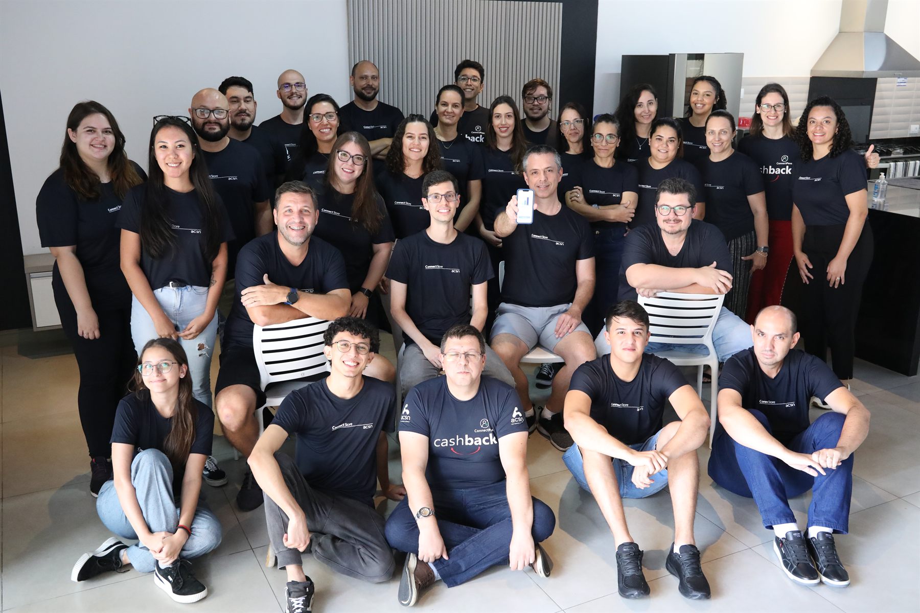 The ACSN team together, around thirty people in black ConnectStore T-shirts.